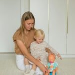 image of child learning potty training with a doll