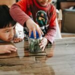 two children are playing with a jar of money