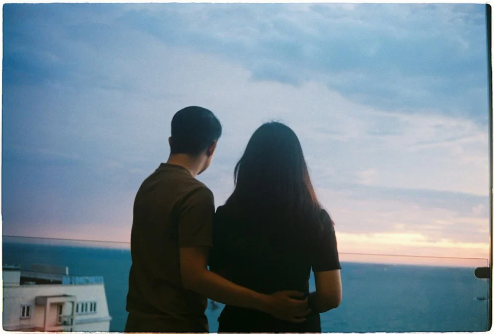 Couple watching the sunset over the ocean