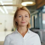 a woman in a white shirt standing in a room