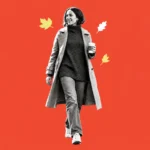 Illustration of a smiling woman in a trench coat walking with coffee among autumn leaves